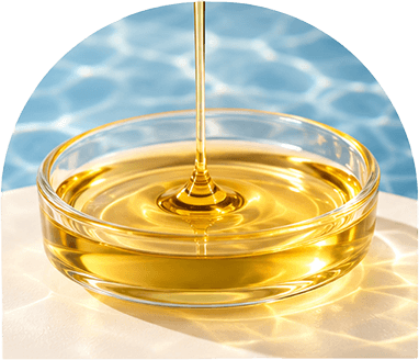 Golden fish oil being poured into a glass dish